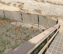 Stairs lead down to a sandy beach