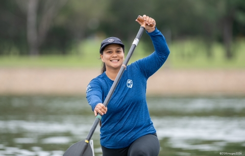 Woman smiling and paddling