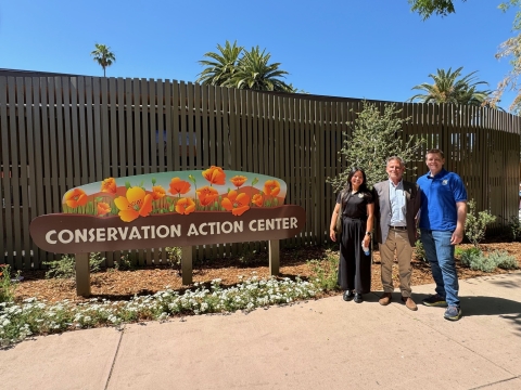 a sign reads "Conservation Action Center" and three USFWS staff stand next to it